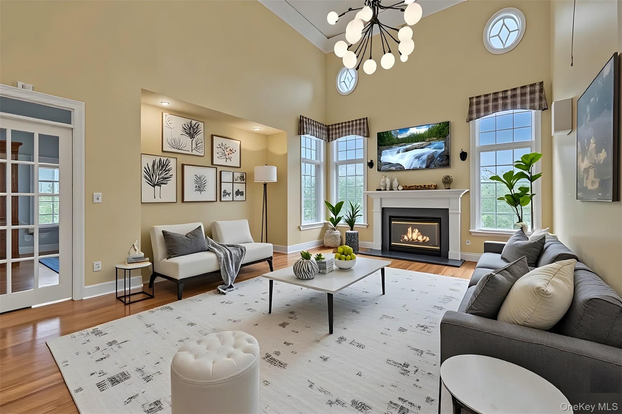 199 Hirst Road Briarcliff Manor, NY 10510 - Photo 13 of 50 The beautiful Family Room with wood-burning Fireplace, double height ceiling/ceiling fan, and hardwood floors; Furniture in this photo virtually staged