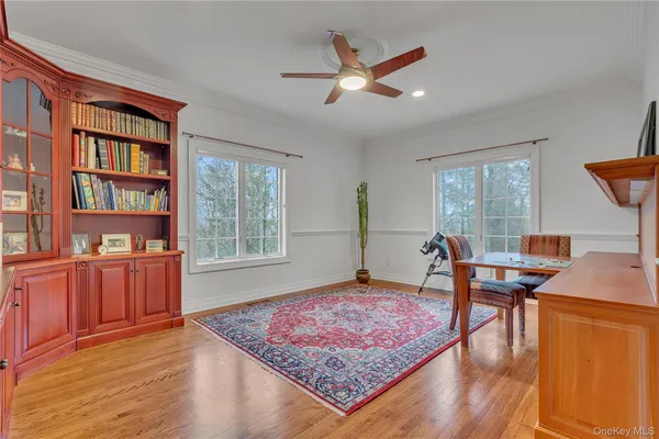 a work room with furniture rug and window