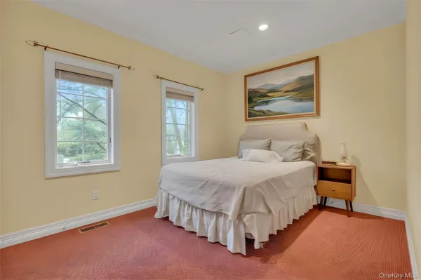 a spacious bedroom with a bed and a window