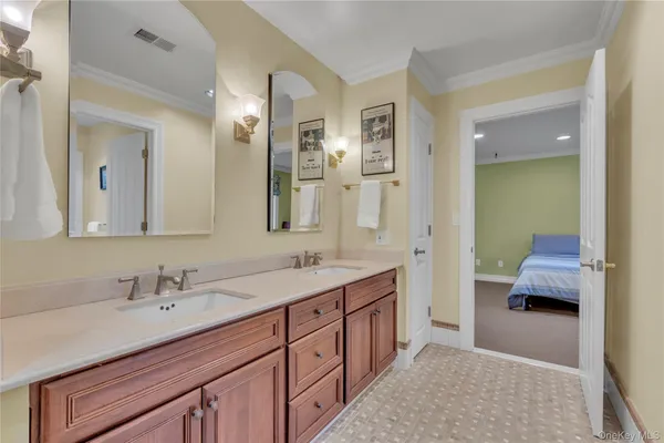 a spacious bathroom with a double vanity sink and mirror