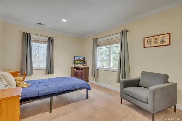 a living room with furniture a bed and a window