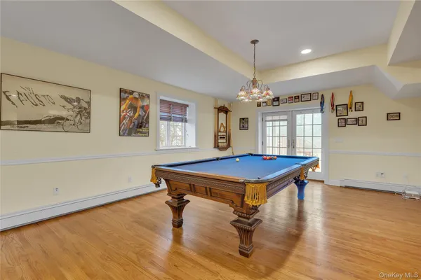 a room with pool table and windows