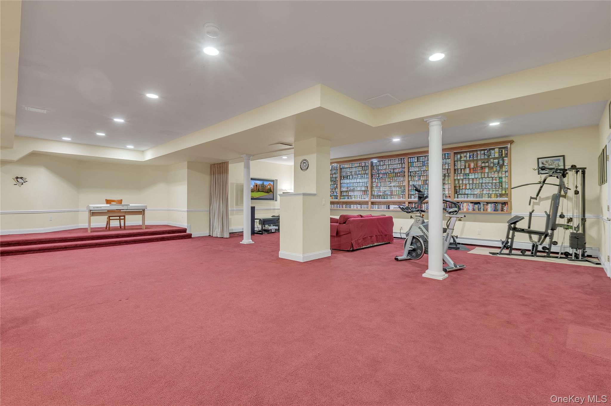 199 Hirst Road Briarcliff Manor, NY 10510 - Photo 42 of 50 Imagine all the possibilities with this much space in your Recreation Room: a stage for performing music or plays, a media room, an exercise space, play area, party room, etc. Note the media & exercise areas with a wall of glass front display shelves.