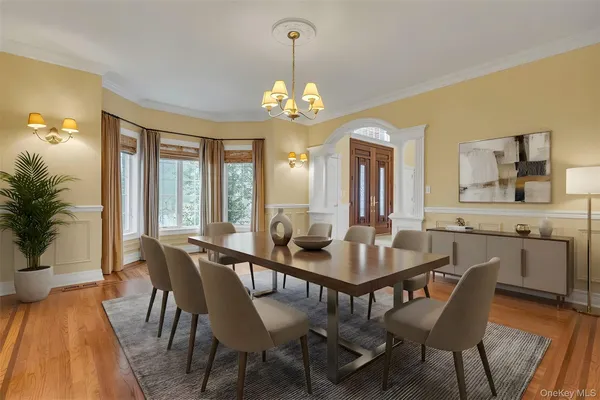 a view of a dining room with furniture window and wooden floor