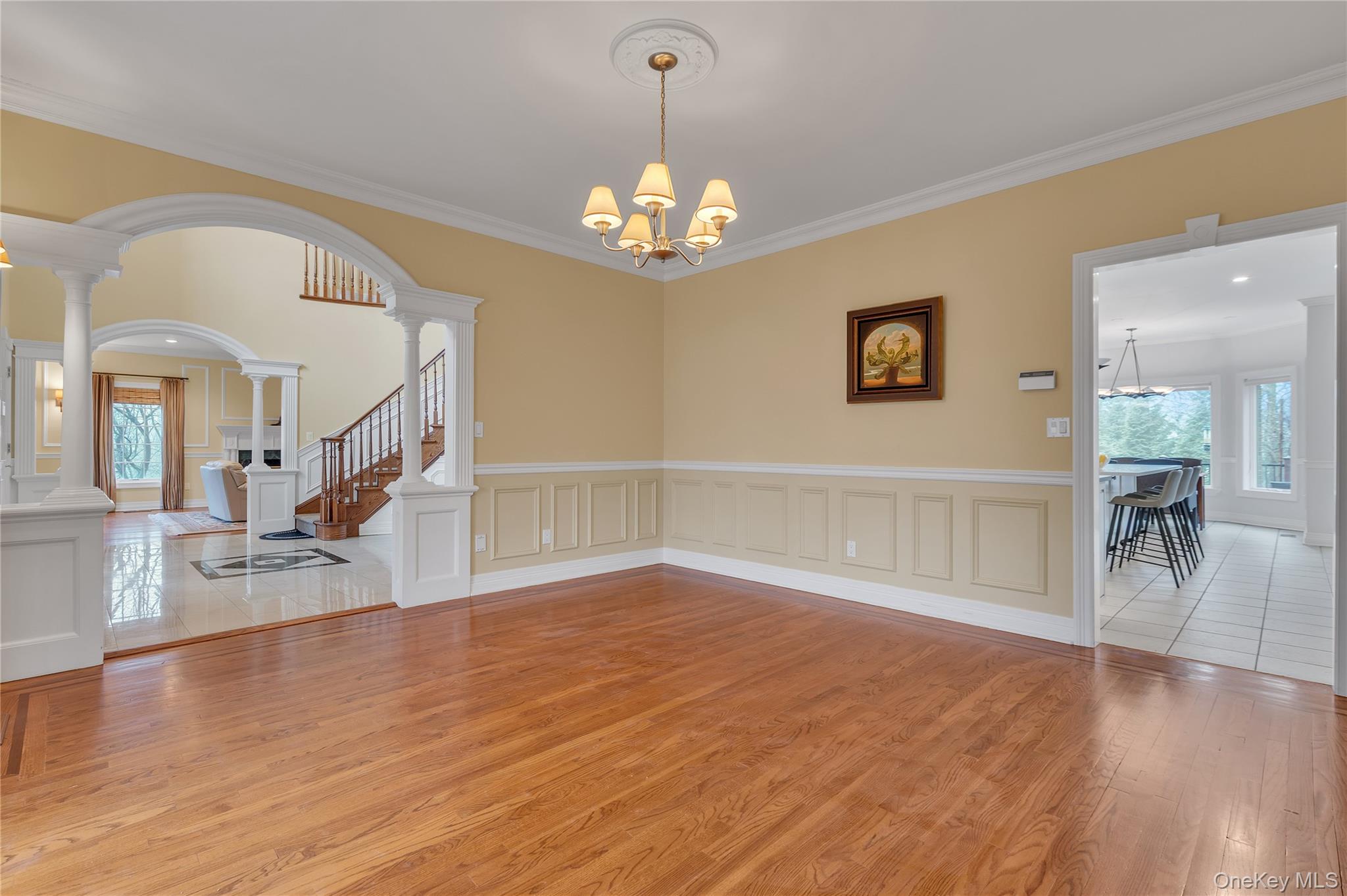 199 Hirst Road Briarcliff Manor, NY 10510 - Photo 6 of 50 View of Dining Room into Entry Foyer through arched opening, and into EIK. FDR with chandelier, hardwood floors & picture frame moldings.