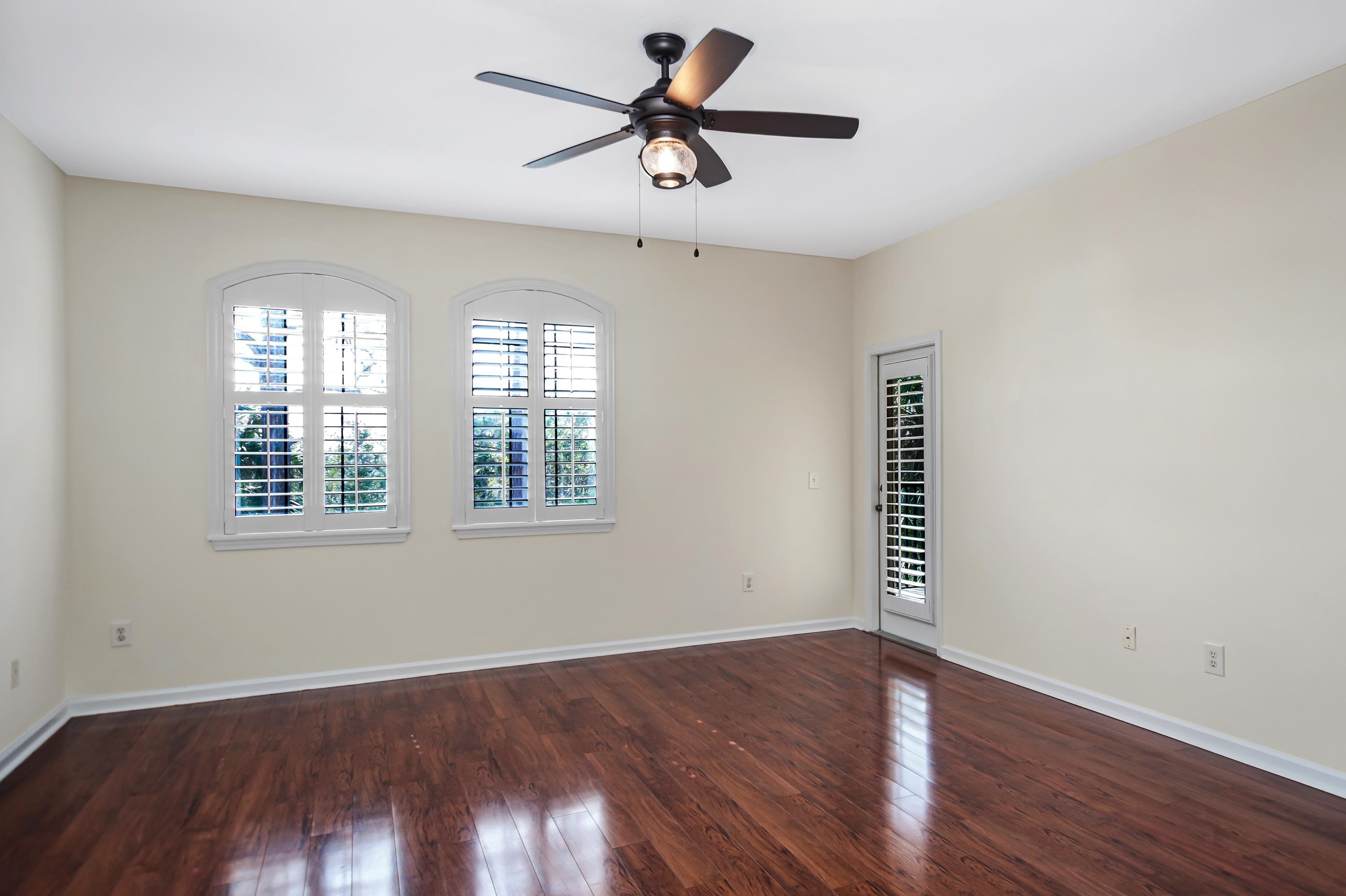 3327 Haley Pointe Road, Unit 3327 St. Augustine, FL 32084 - Photo 12 of 27 an empty room with wooden floor chandelier fan and windows