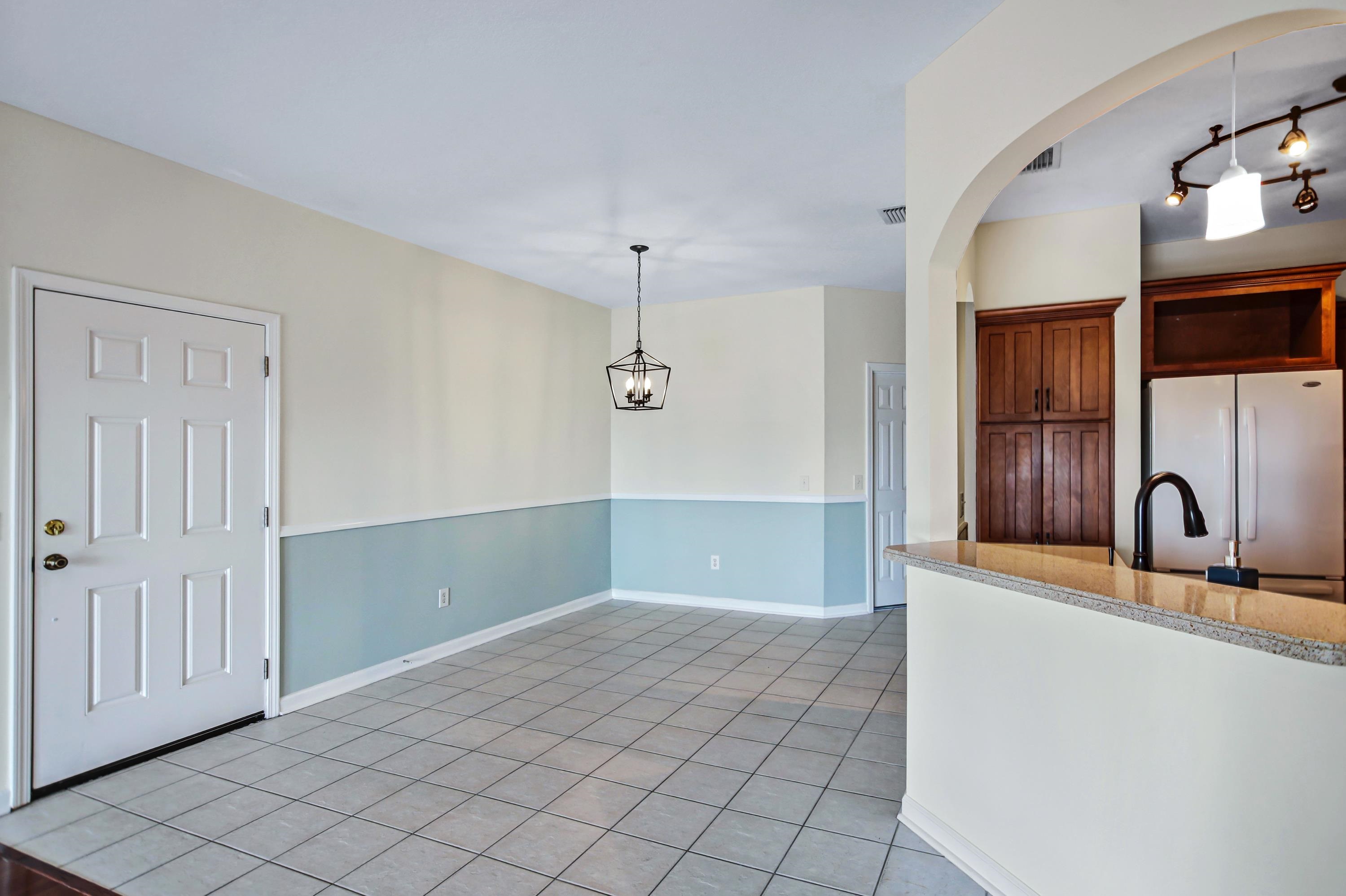 3327 Haley Pointe Road, Unit 3327 St. Augustine, FL 32084 - Photo 5 of 27 a kitchen with granite countertop a coffee maker a sink and dishwasher