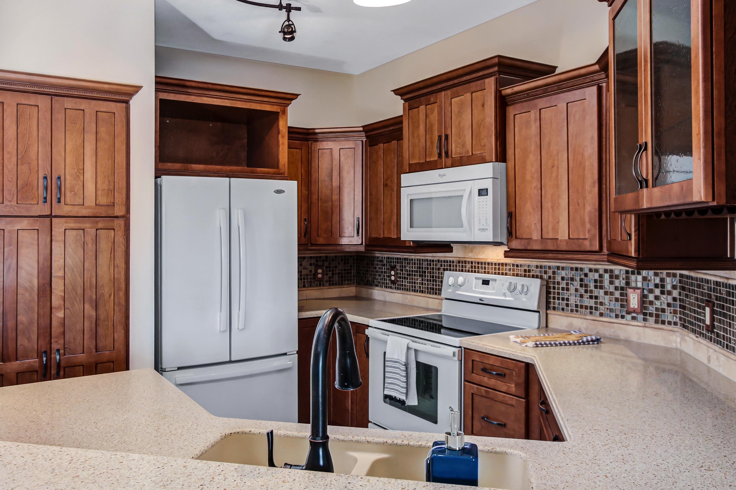 3327 Haley Pointe Road, Unit 3327 St. Augustine, FL 32084 - Photo 9 of 27 a kitchen with stainless steel appliances granite countertop a refrigerator and a stove top oven