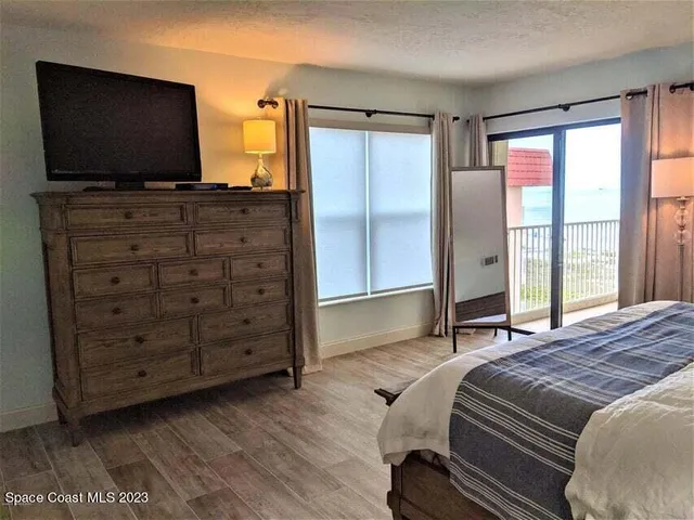 a bedroom with a bed and flat screen tv