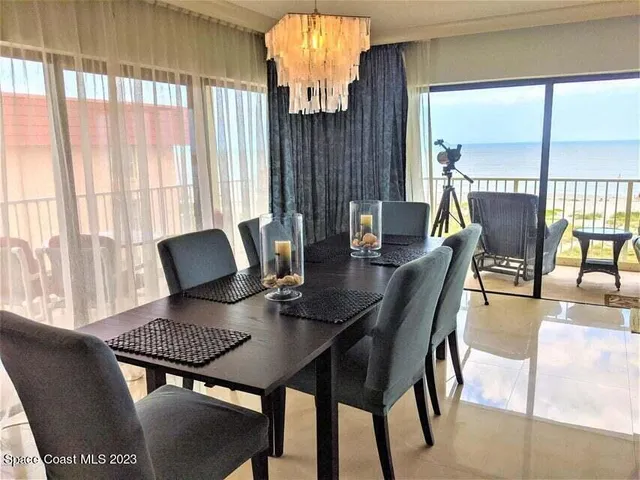 a view of a dining room with furniture and a window