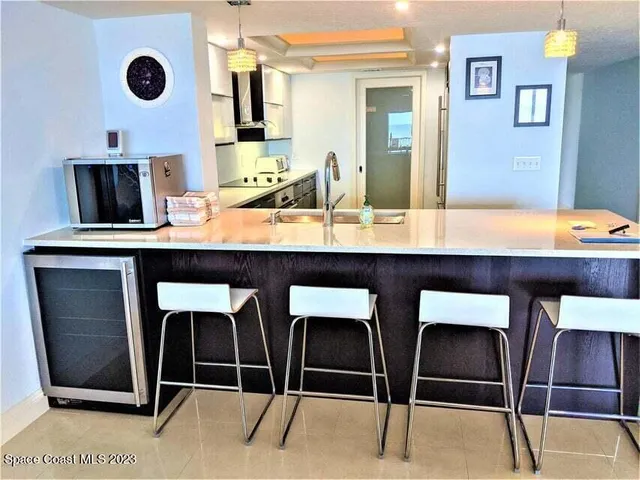 a kitchen with cabinets and chairs
