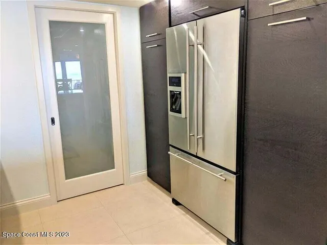 a view of kitchen with stainless steel appliances refrigerator stove and closet