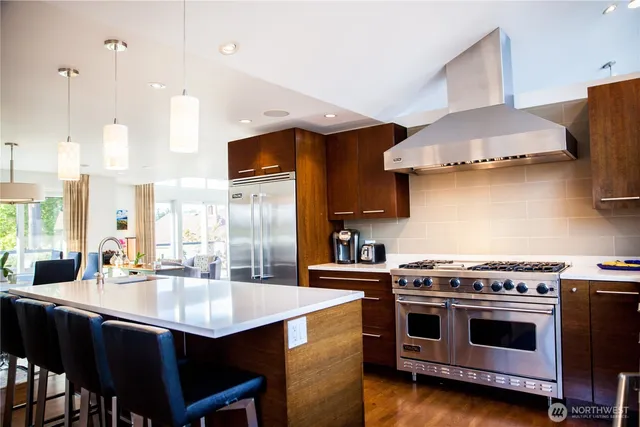 a kitchen with a stove a sink and a refrigerator