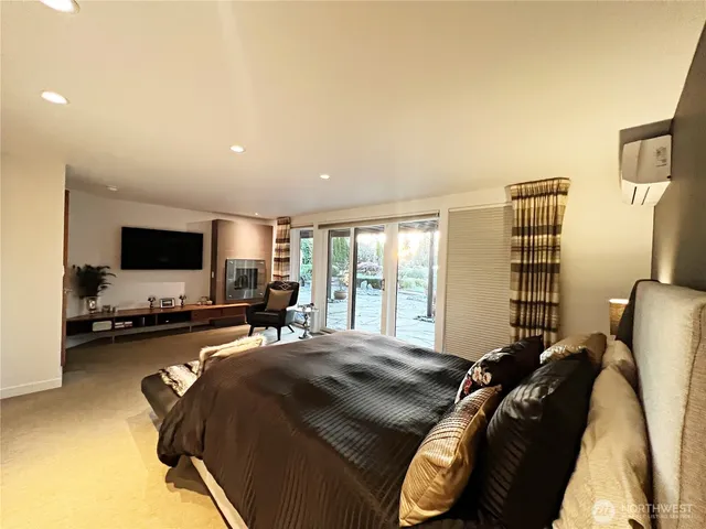 a bedroom with a bed and flat screen tv