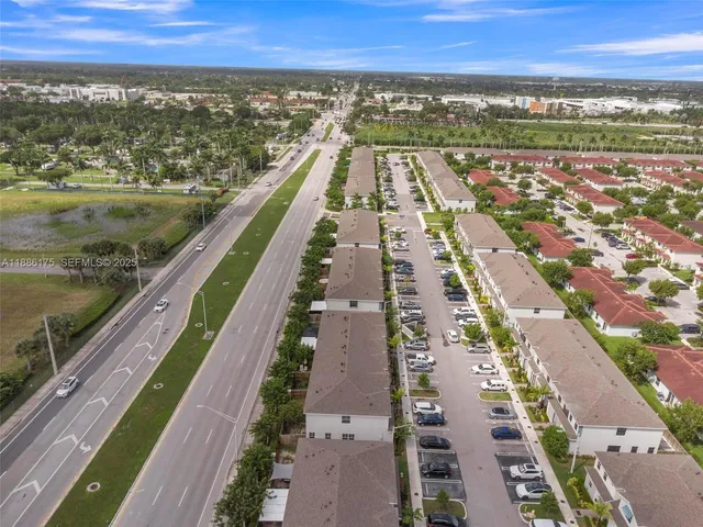 an aerial view of residential houses with city view