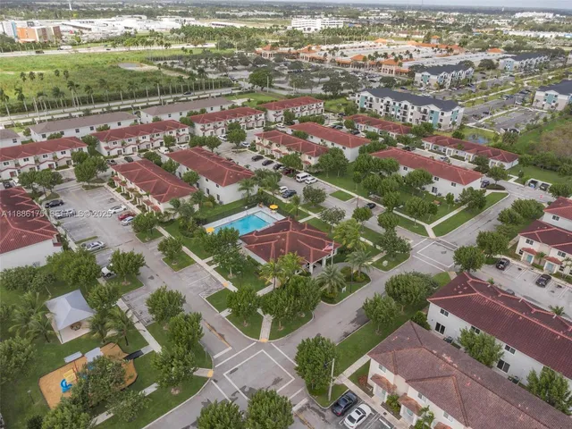 an aerial view of residential houses with outdoor space