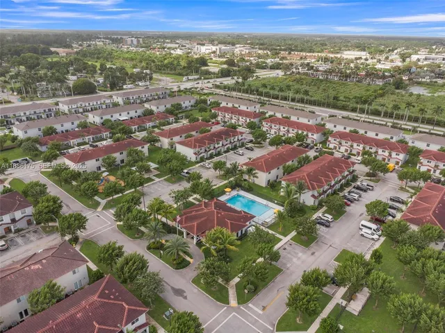 an aerial view of a house with a garden and swimming pool