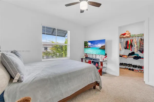 a bed room with a bed and a flat tv screen