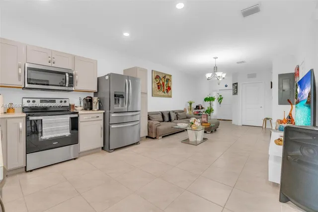 a kitchen with sink cabinets and stainless steel appliances