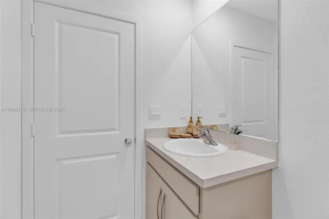 a bathroom with a sink toilet a mirror and shower