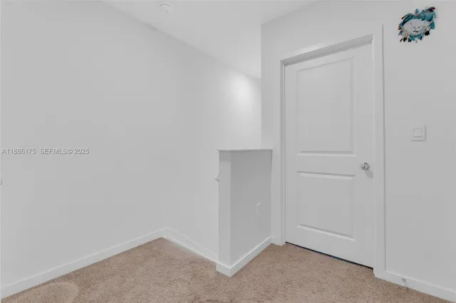 a patio with table and chairs and potted plants