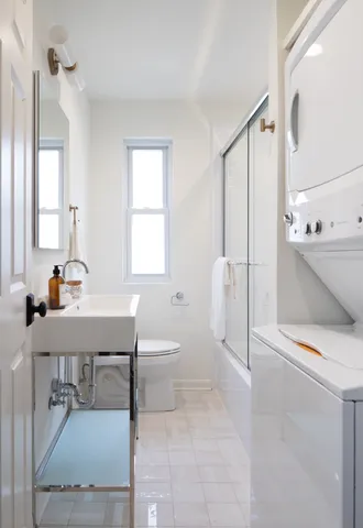 a bathroom with a sink toilet and shower