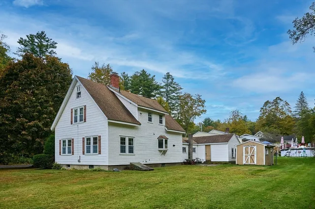 a front view of a house with a garden and yard