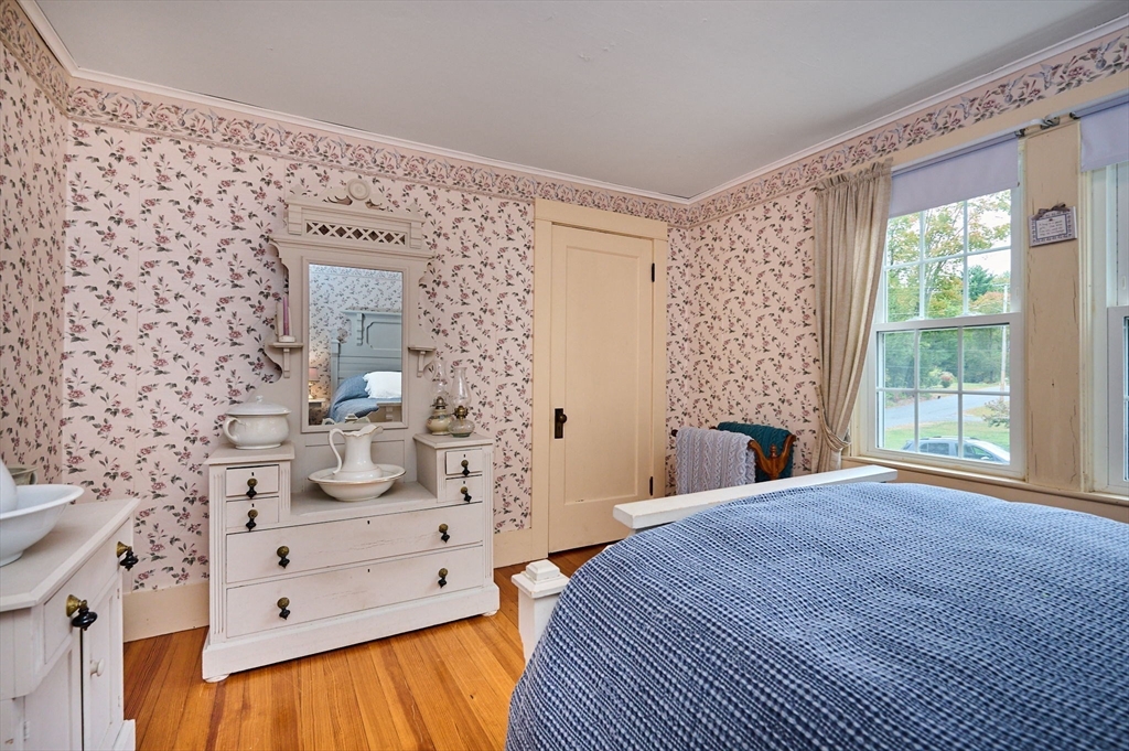 102 Elm Street Buckland, MA 01370 - Photo 18 of 35 a spacious bedroom with a bed and a fireplace