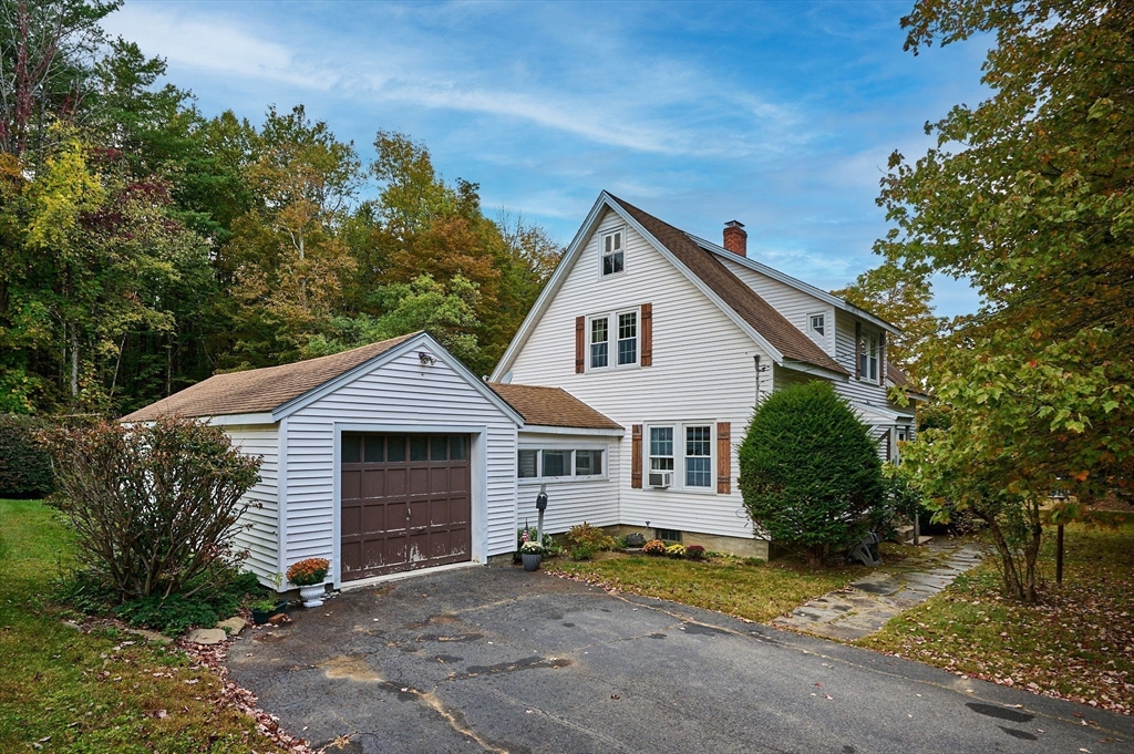 102 Elm Street Buckland, MA 01370 - Photo 2 of 35 a front view of a house with a yard and garage