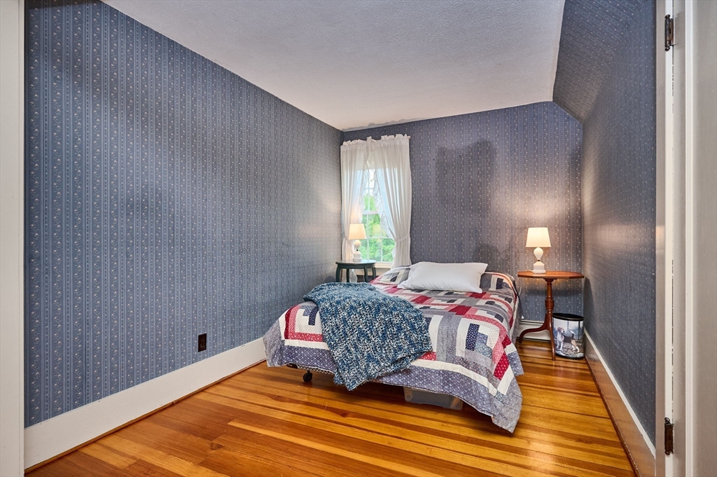 102 Elm Street Buckland, MA 01370 - Photo 22 of 35 a bedroom with a bed and wooden floor