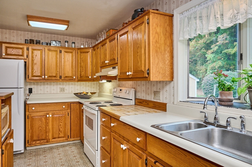 102 Elm Street Buckland, MA 01370 - Photo 8 of 35 a kitchen with a sink a counter top space cabinets and a window