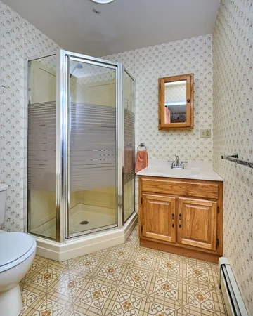 a bathroom with a granite countertop sink a mirror and a shower