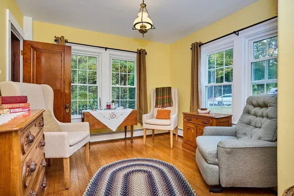 a living room with fireplace furniture and floor to ceiling windows
