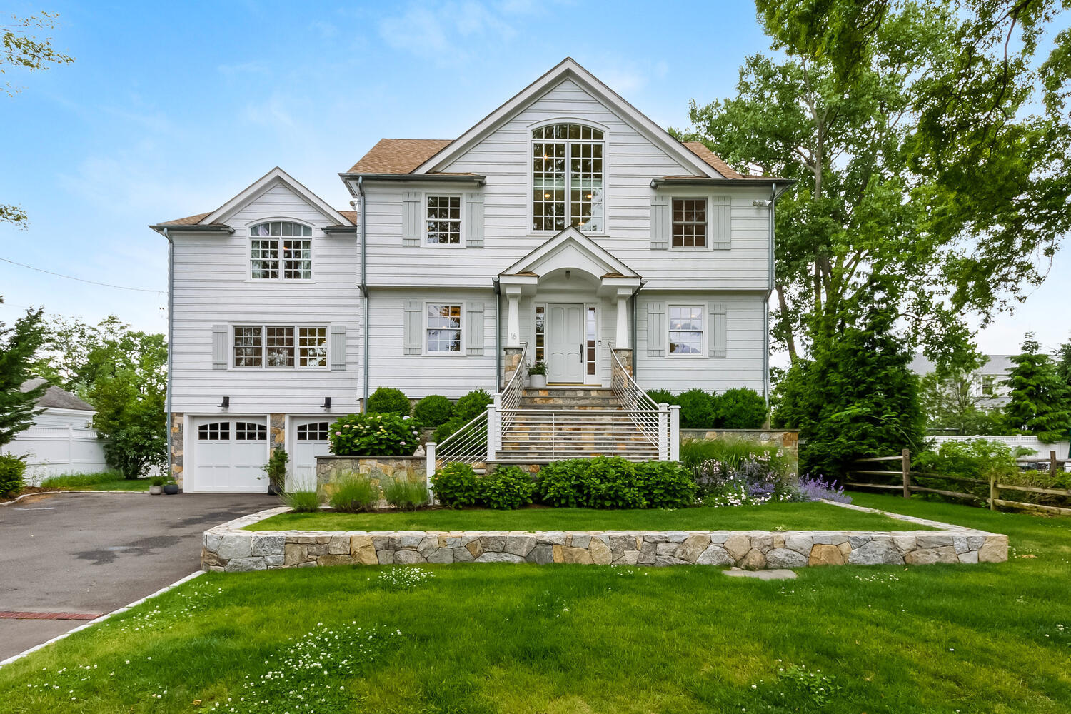 16 Mayflower Road Darien, CT 06820 - Photo 2 of 35 a front view of a house with a yard and garage
