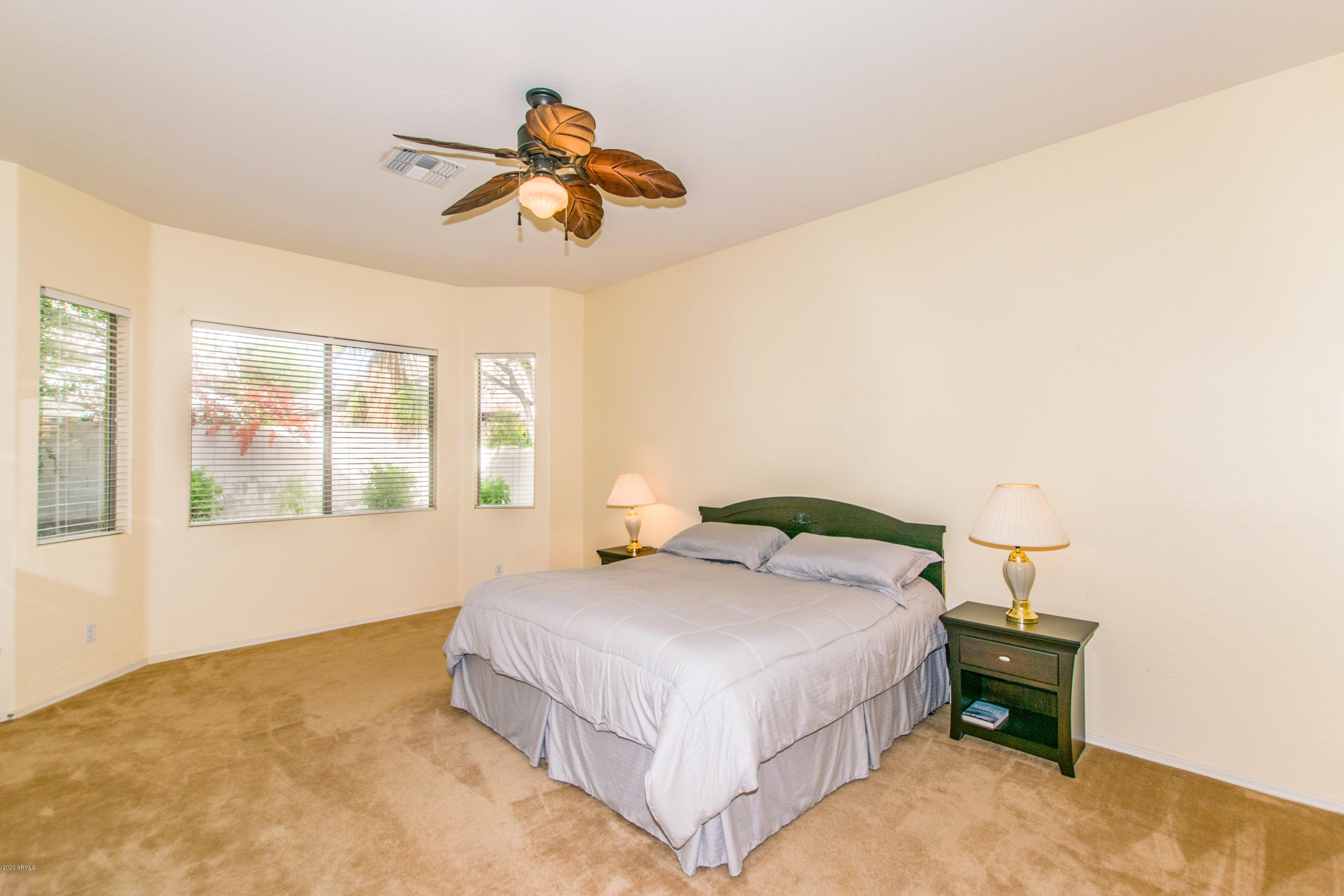 2426 West Apache Rain Road Phoenix, AZ 85085 - Photo 11 of 27 a bedroom with a bed and a window