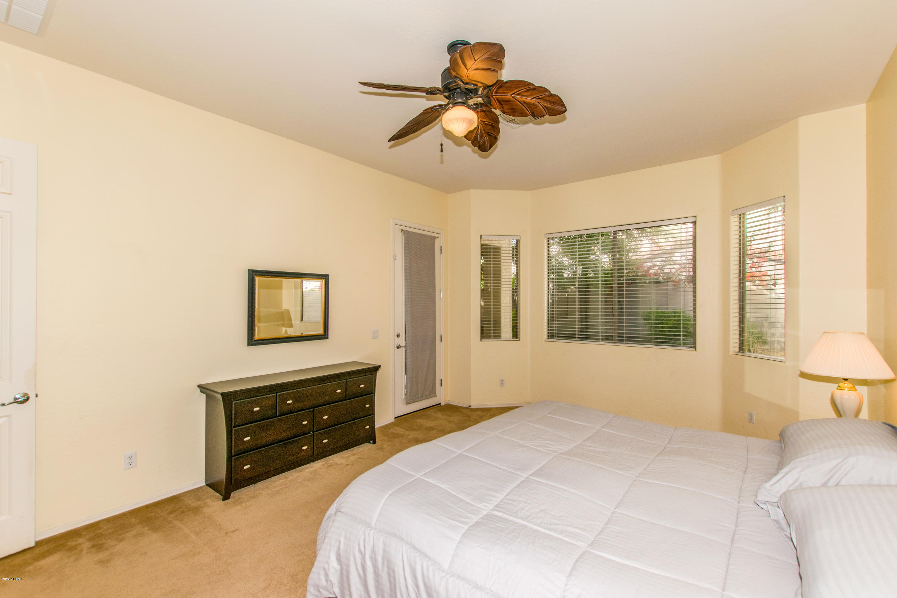 2426 West Apache Rain Road Phoenix, AZ 85085 - Photo 12 of 27 a bedroom with a bed and a painting on the wall