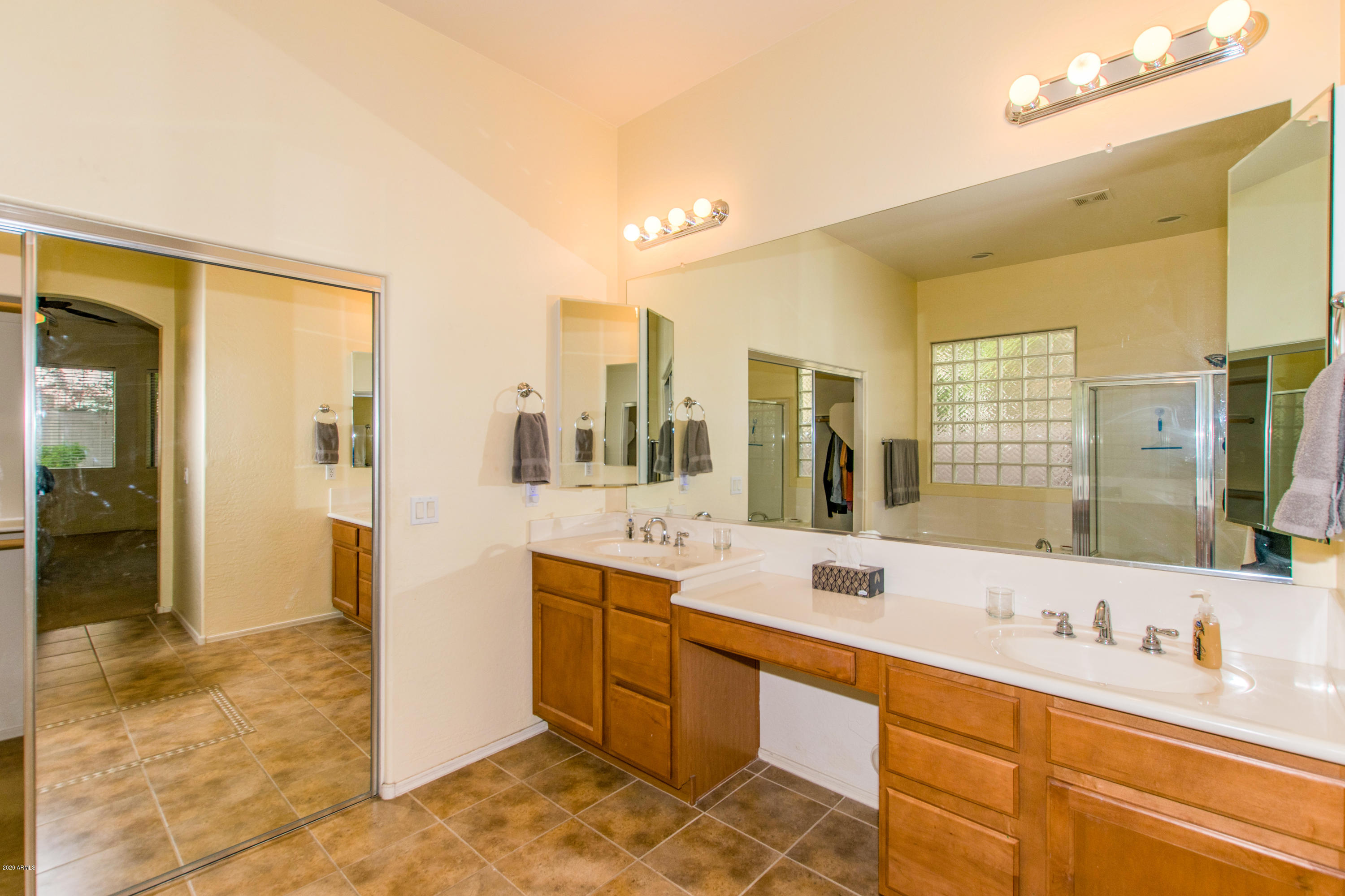 2426 West Apache Rain Road Phoenix, AZ 85085 - Photo 14 of 27 a spacious bathroom with a double vanity sink a mirror and a shower
