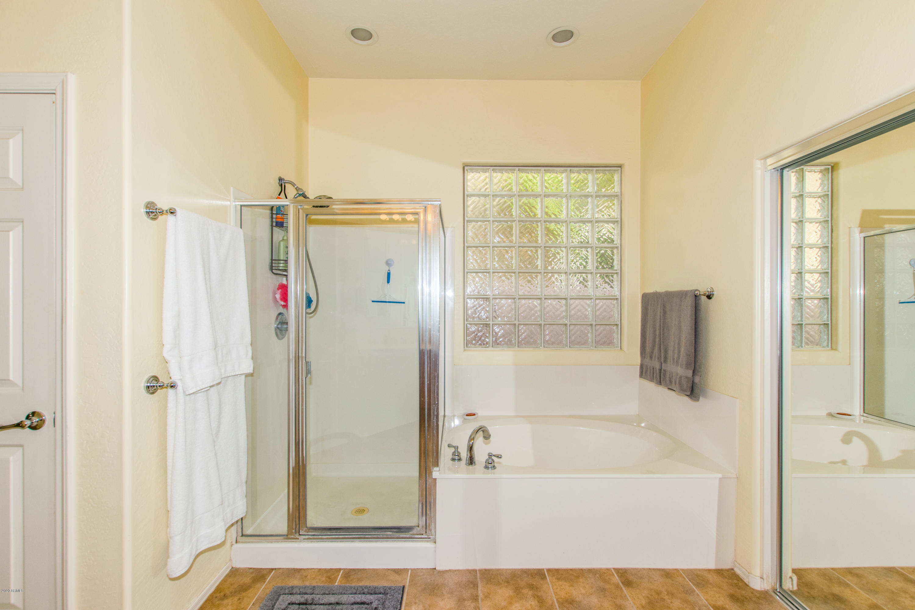 2426 West Apache Rain Road Phoenix, AZ 85085 - Photo 15 of 27 a bathroom with a bathtub and a shower