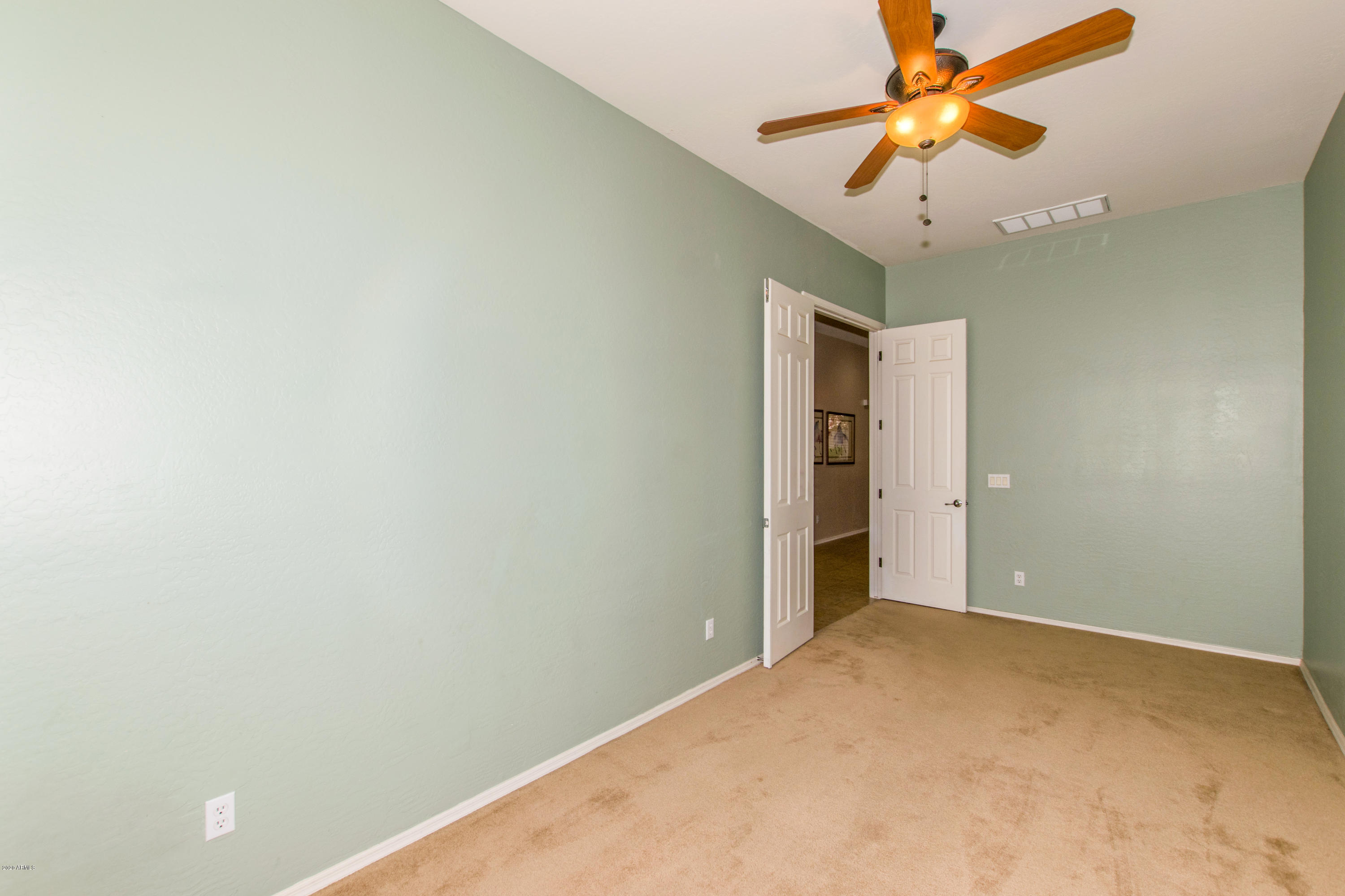 2426 West Apache Rain Road Phoenix, AZ 85085 - Photo 17 of 27 an empty room with a fan and a fan