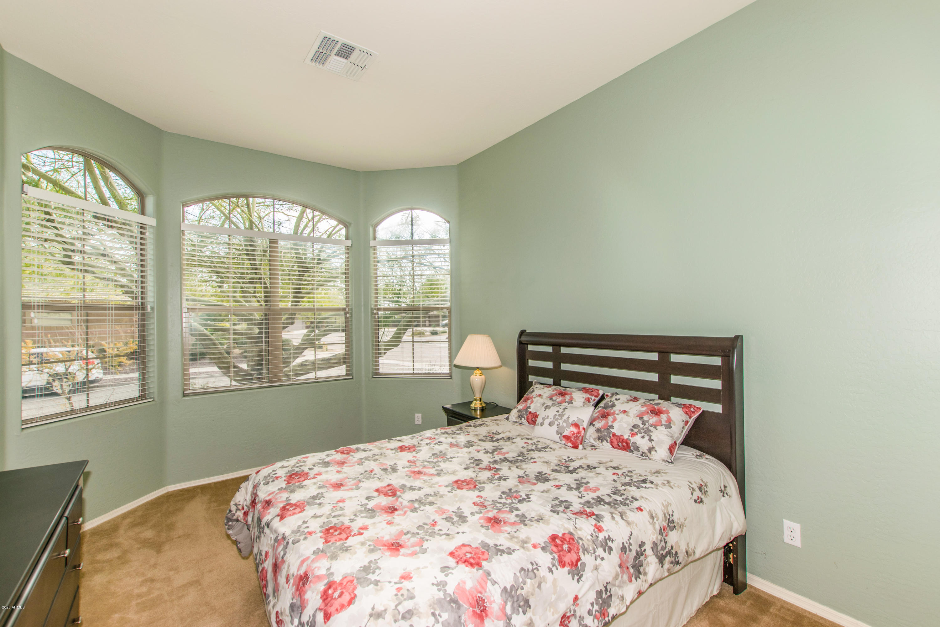 2426 West Apache Rain Road Phoenix, AZ 85085 - Photo 18 of 27 a bedroom with a large bed and a window