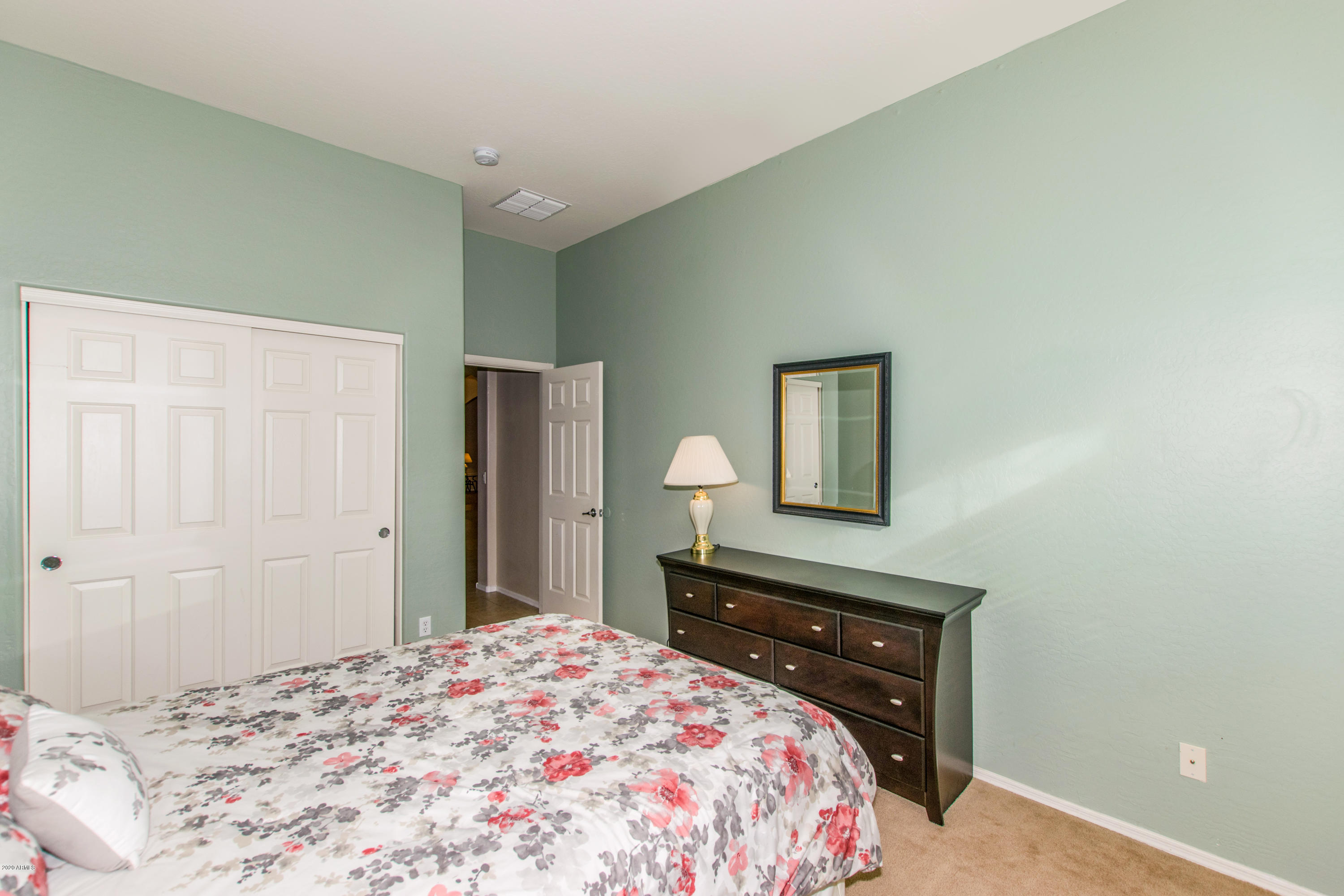 2426 West Apache Rain Road Phoenix, AZ 85085 - Photo 19 of 27 a bedroom with a bed and a dresser