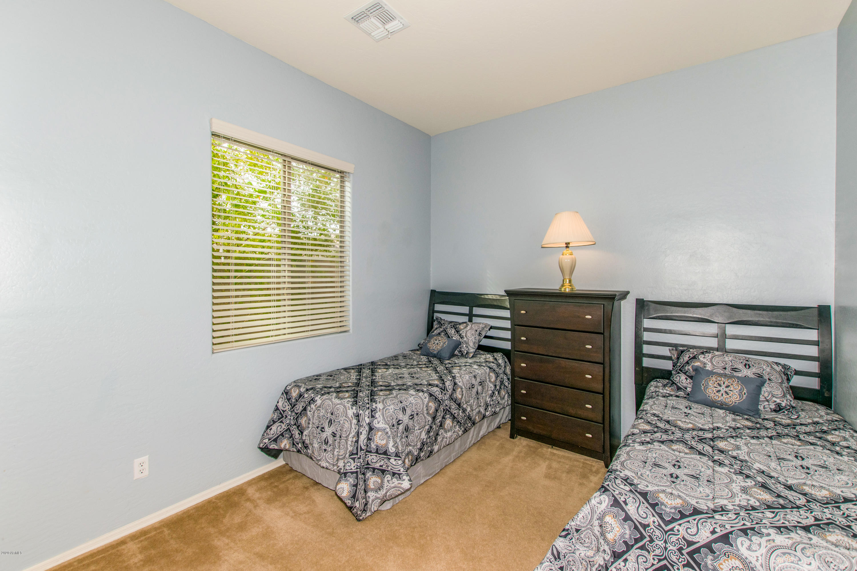 2426 West Apache Rain Road Phoenix, AZ 85085 - Photo 20 of 27 a bedroom with a bed and a dresser