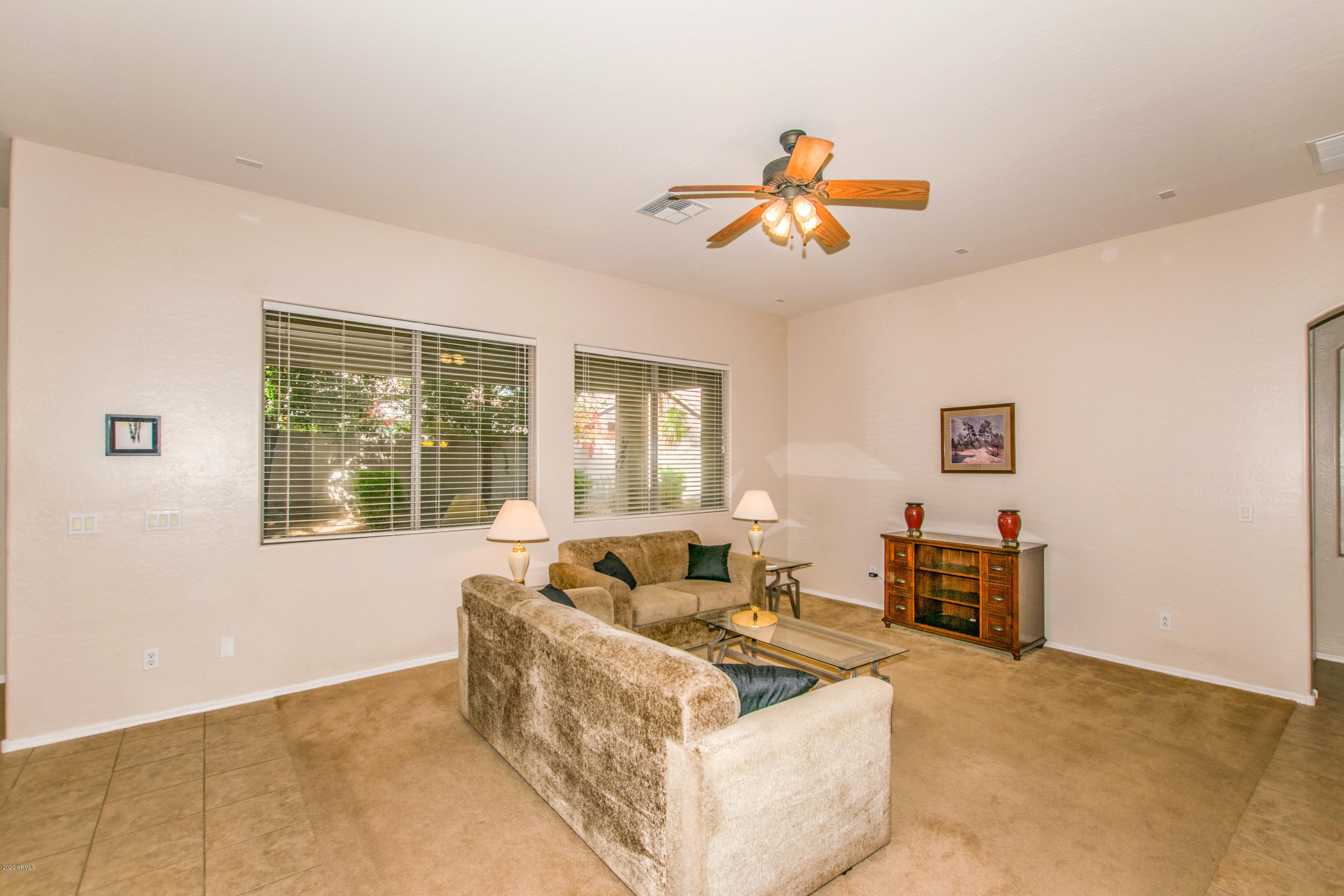 2426 West Apache Rain Road Phoenix, AZ 85085 - Photo 2 of 27 a living room with furniture and a window