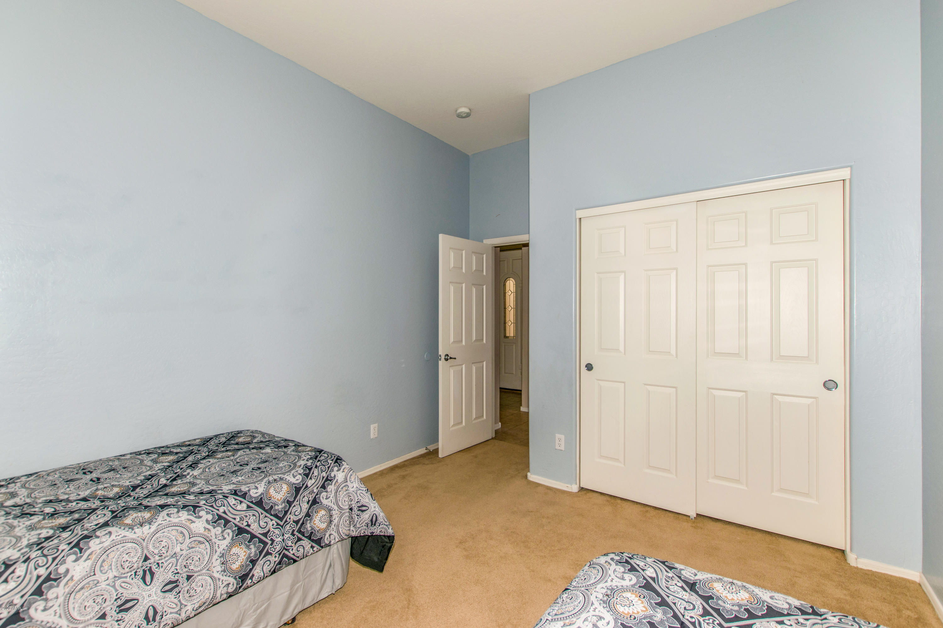 2426 West Apache Rain Road Phoenix, AZ 85085 - Photo 21 of 27 a bedroom with a bed and a closet