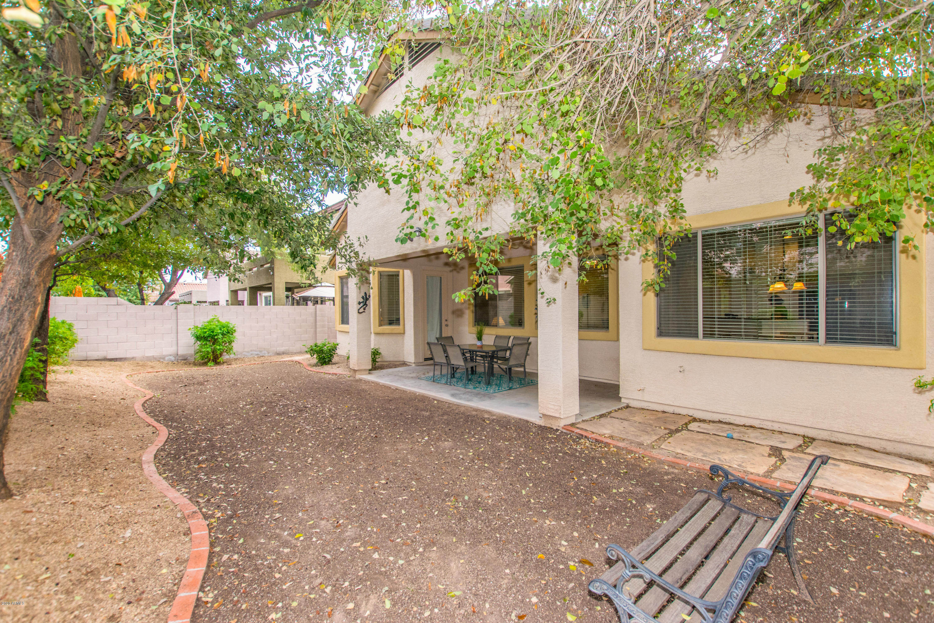 2426 West Apache Rain Road Phoenix, AZ 85085 - Photo 25 of 27 a view of a house with a tree and pathway