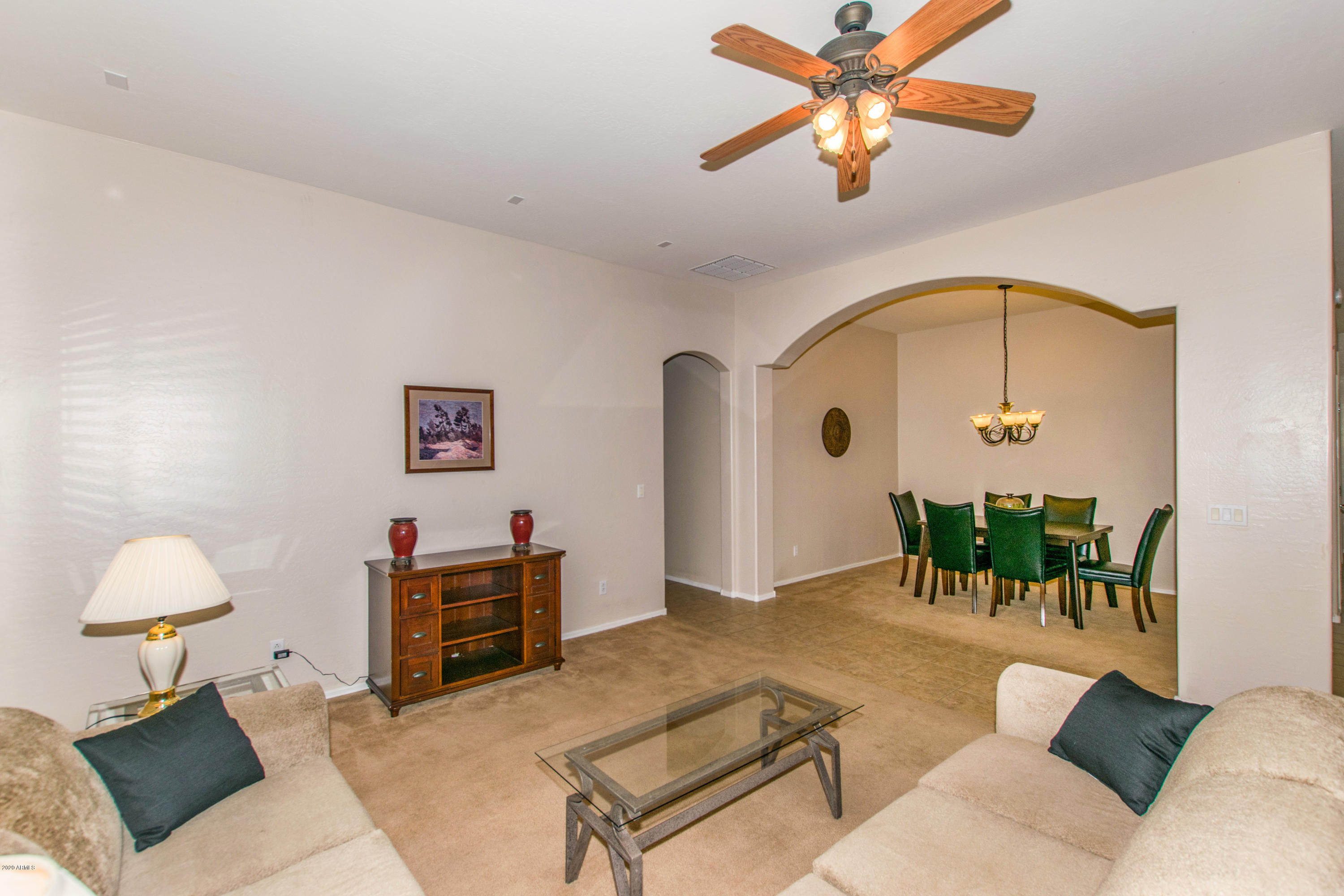 2426 West Apache Rain Road Phoenix, AZ 85085 - Photo 3 of 27 a living room with furniture and a chandelier