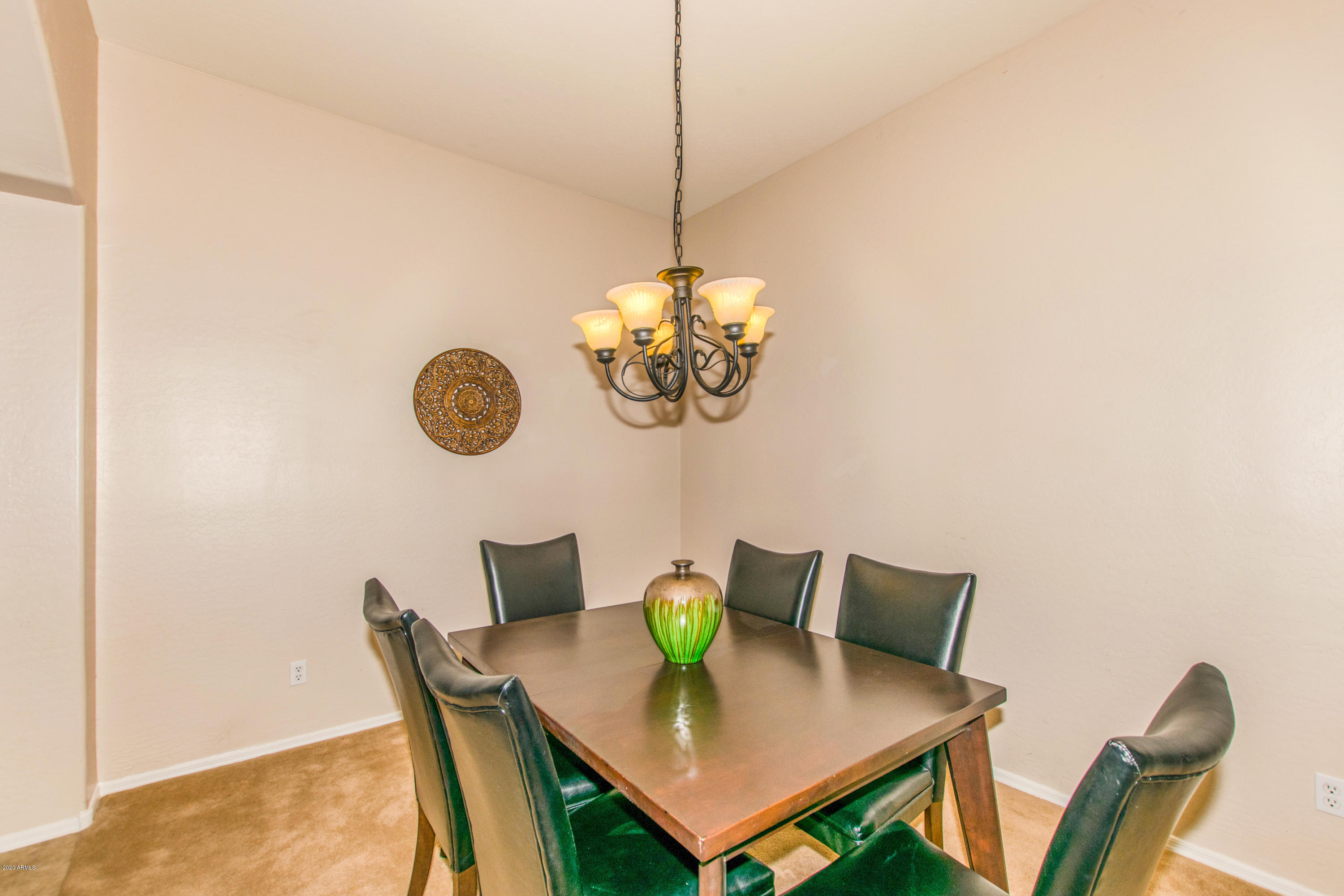 2426 West Apache Rain Road Phoenix, AZ 85085 - Photo 9 of 27 a view of a dining room with furniture and wooden floor