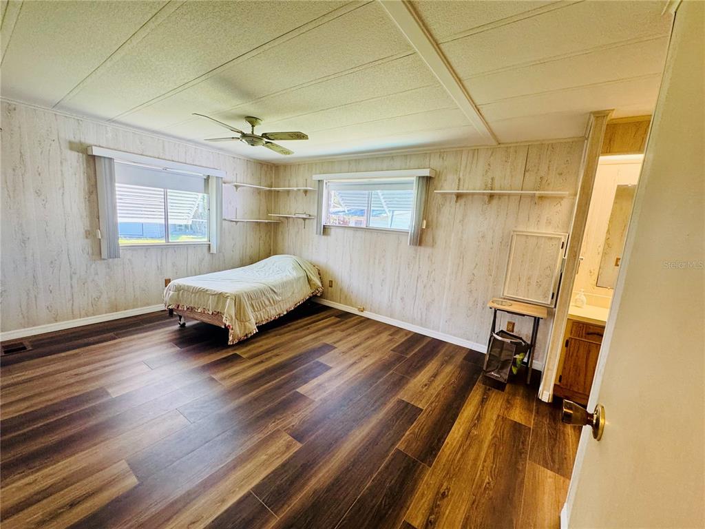127 Ash Street Edgewater, FL 32141 - Photo 8 of 13 a spacious bedroom with a bed and a window