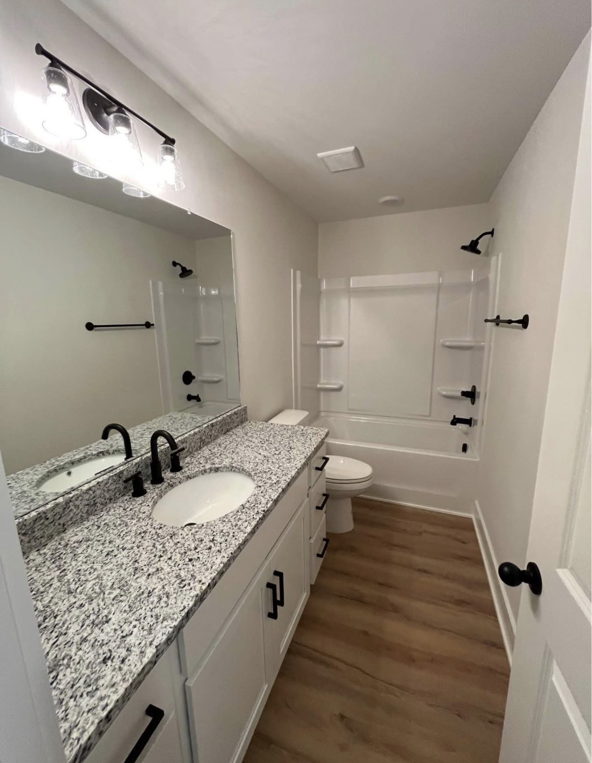 402 Portland Boulevard Portland, TN 37148 - Photo 14 of 16 a bathroom with a granite countertop sink and a mirror