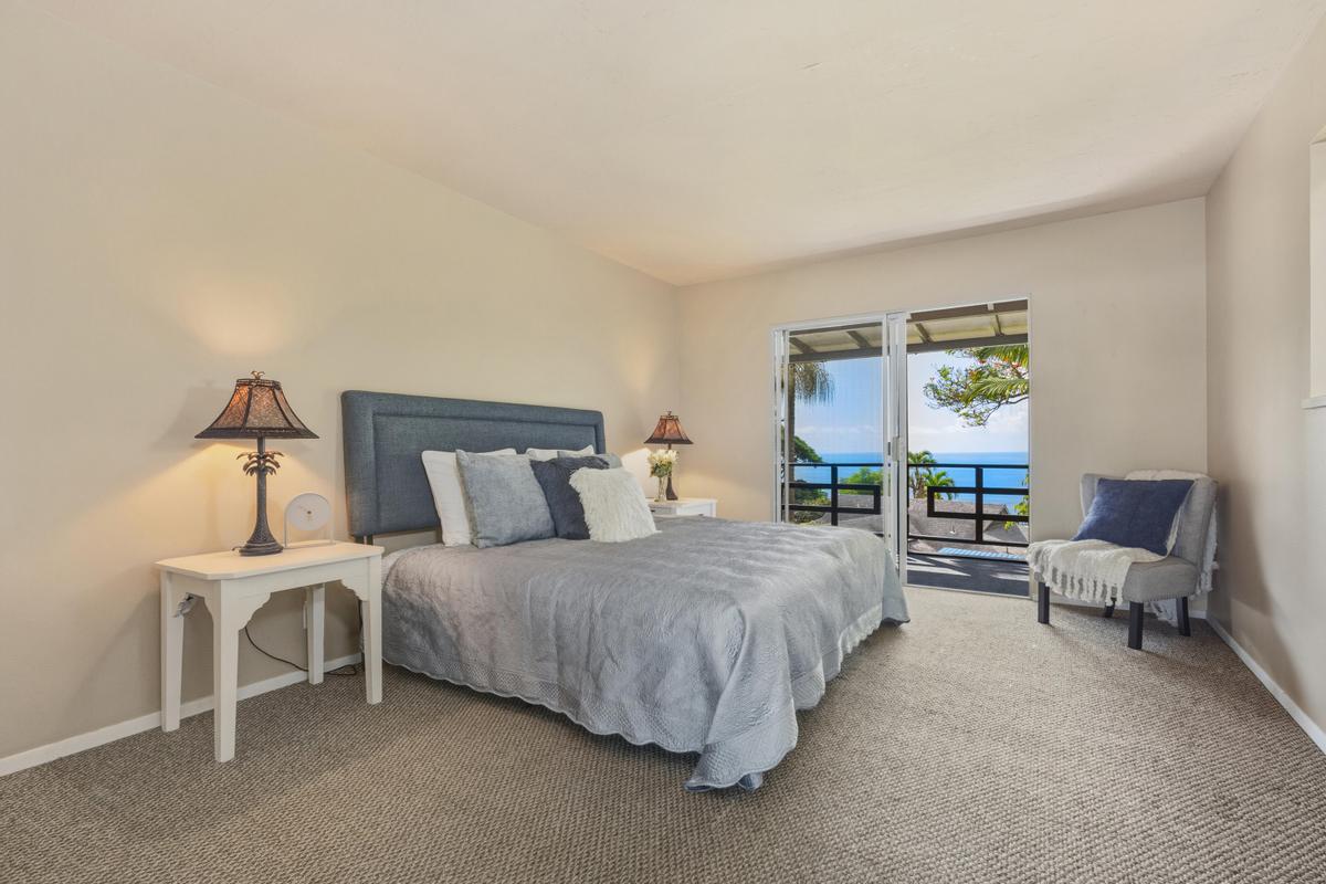 77-6484 Ono Road Kailua-Kona, HI 96740 - Photo 22 of 29 a bedroom with a bed and lamp